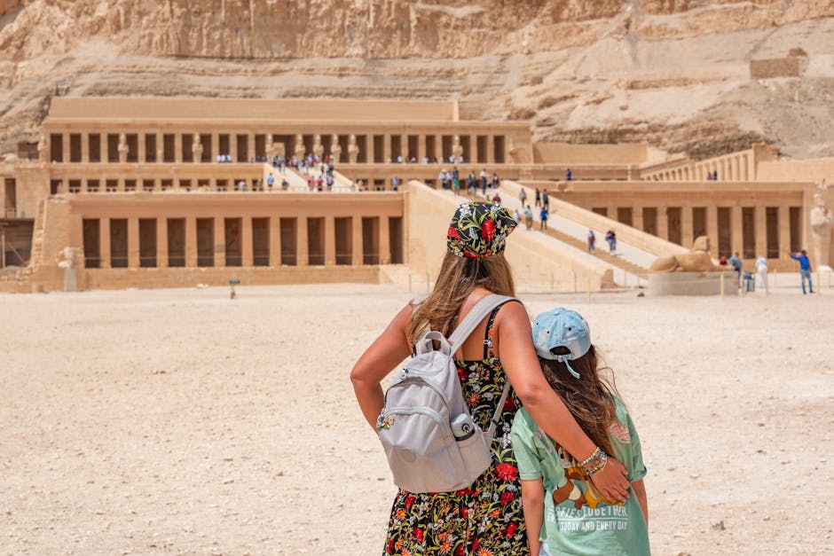 A woman and child explore the historic Temple of Hatshepsut in Egypt.