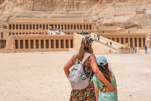 A woman and child explore the historic Temple of Hatshepsut in Egypt.