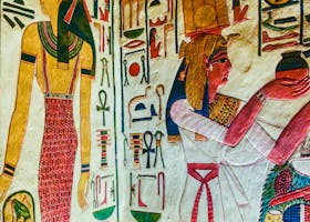 Vibrant ancient Egyptian mural featuring gods and hieroglyphics on a wall.