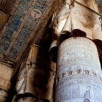 Detailed view of the ornate columns and hieroglyphs inside the ancient Dendera Temple in Egypt.
