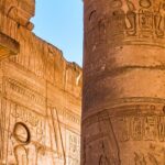 Sunlit columns with hieroglyphs at the ancient Karnak Temple in Luxor, Egypt.